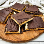 Pieces of cookie dough bark on wooden cutting board