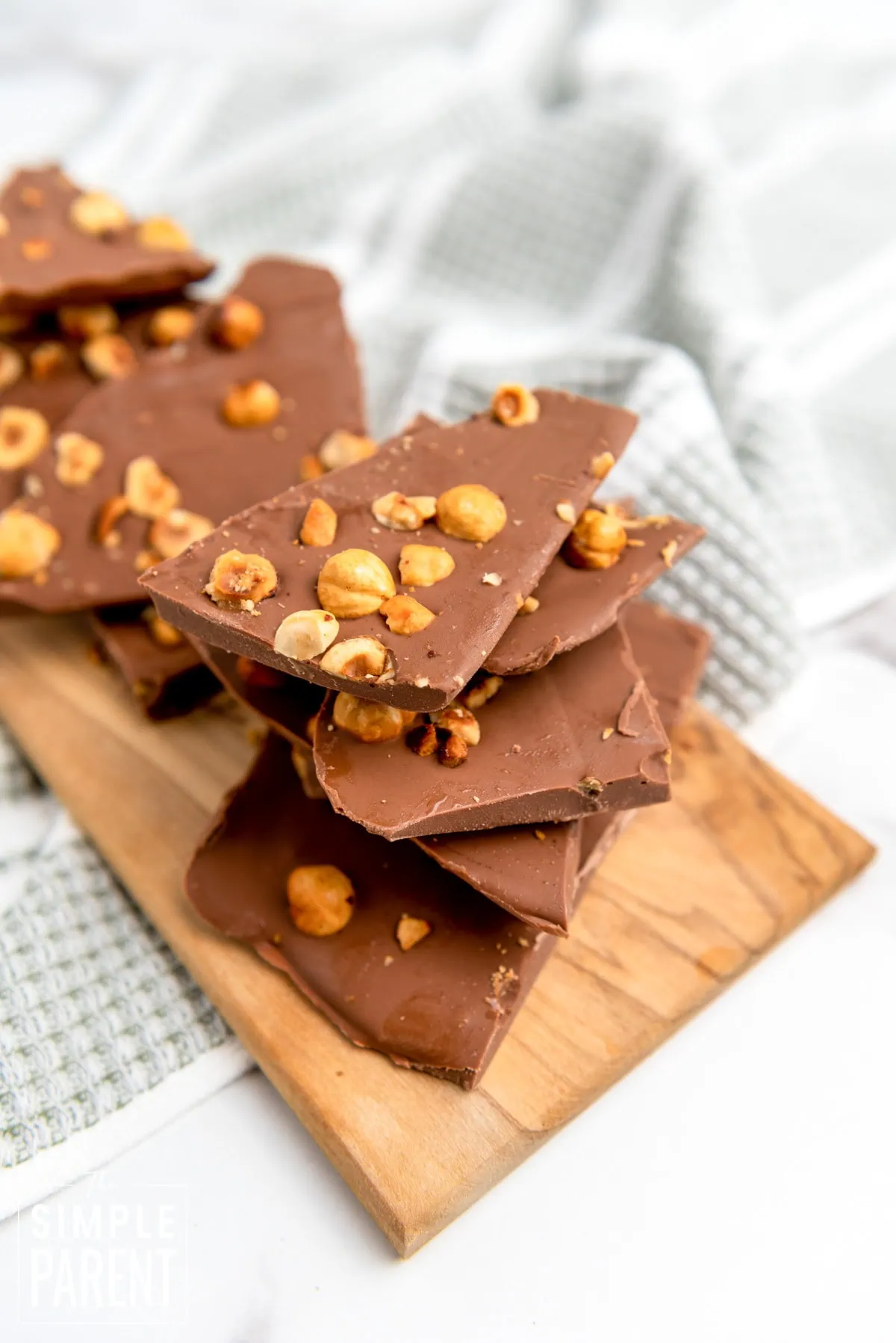 Pieces of hazelnut bark stacked on a wooden cutting board