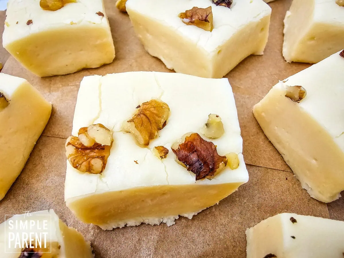 Maple condensed milk fudge squares on wooden plate