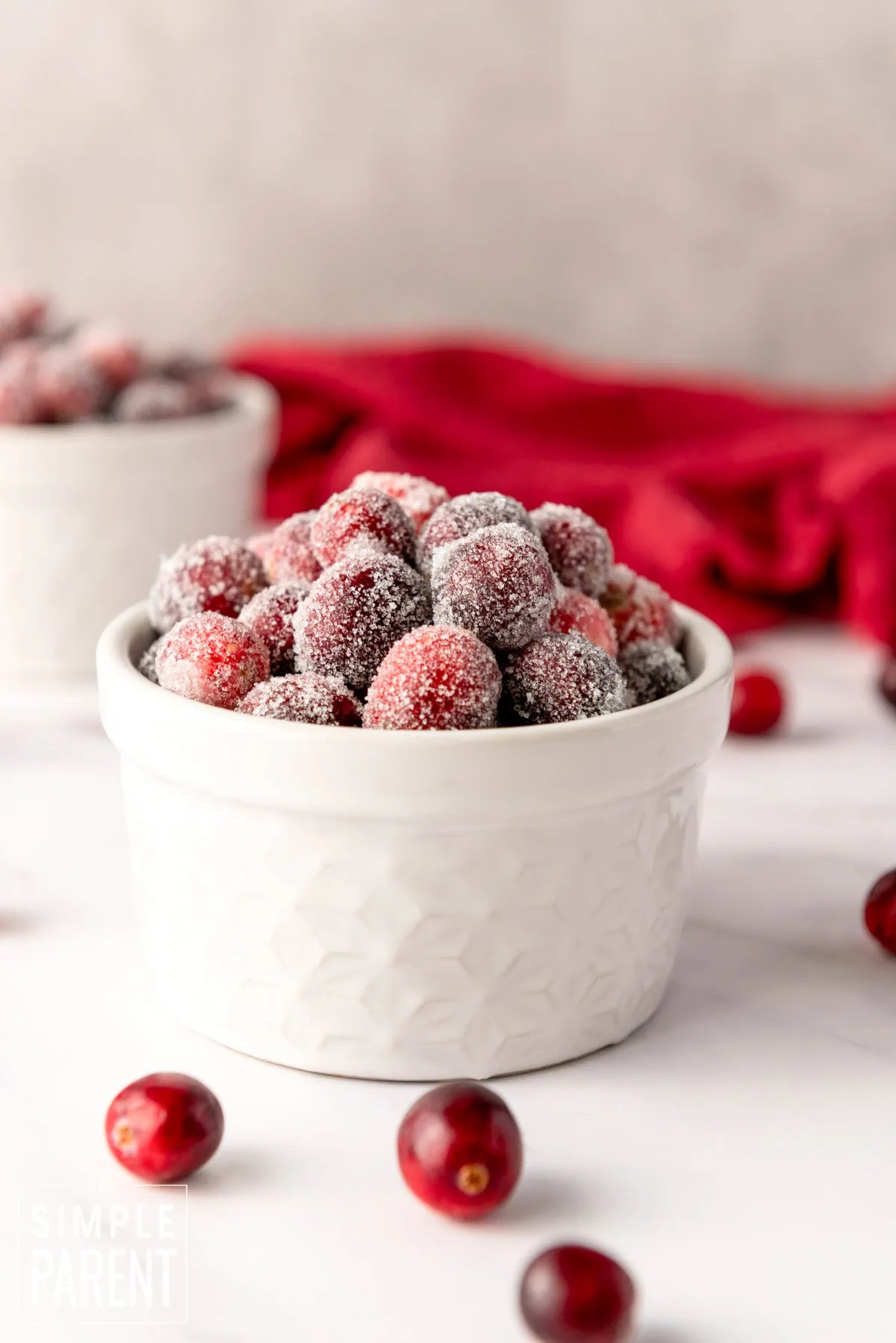 Sugar covered cranberries in a white bowl