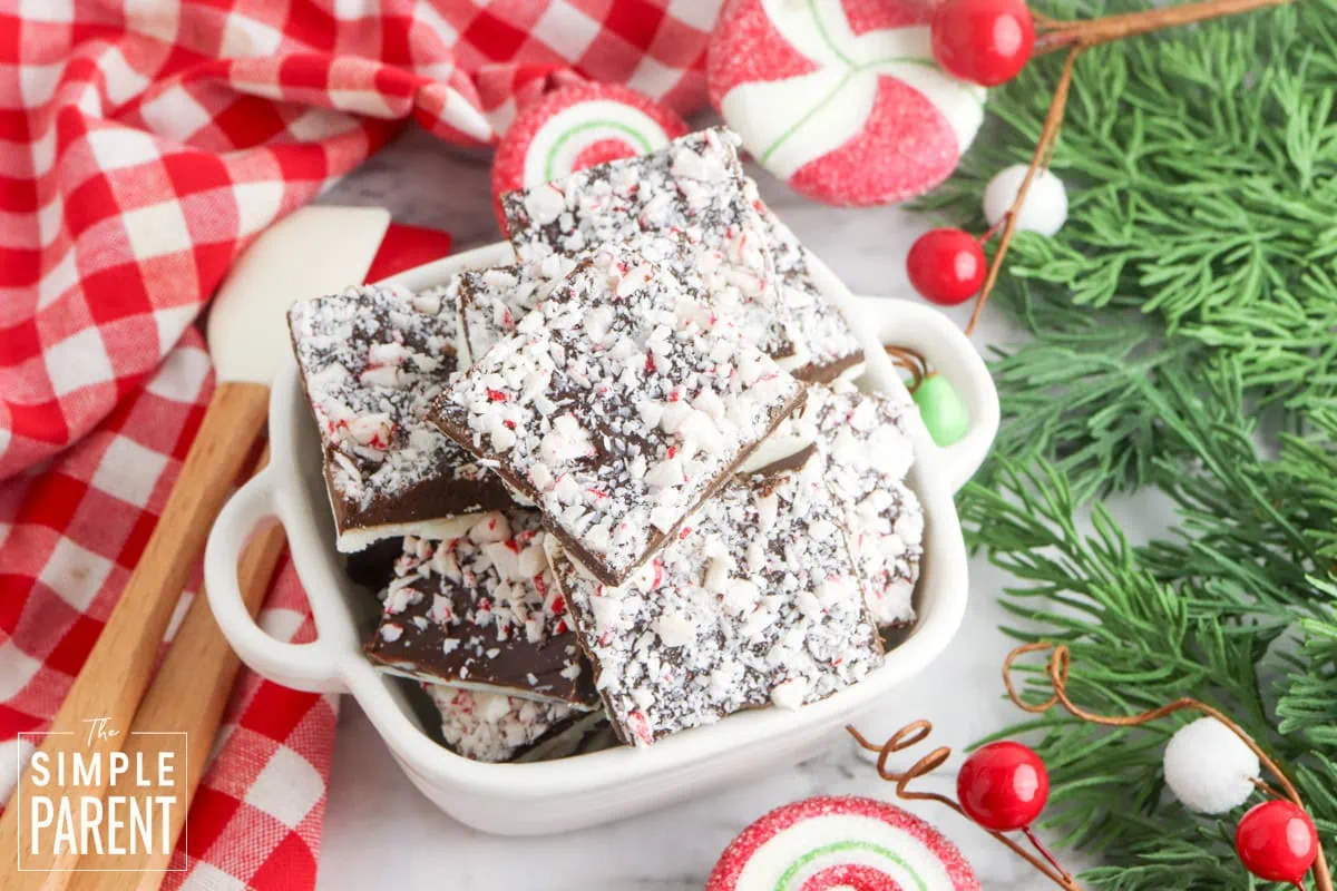 White chocolate peppermint bark in white bowl with red and white napkin