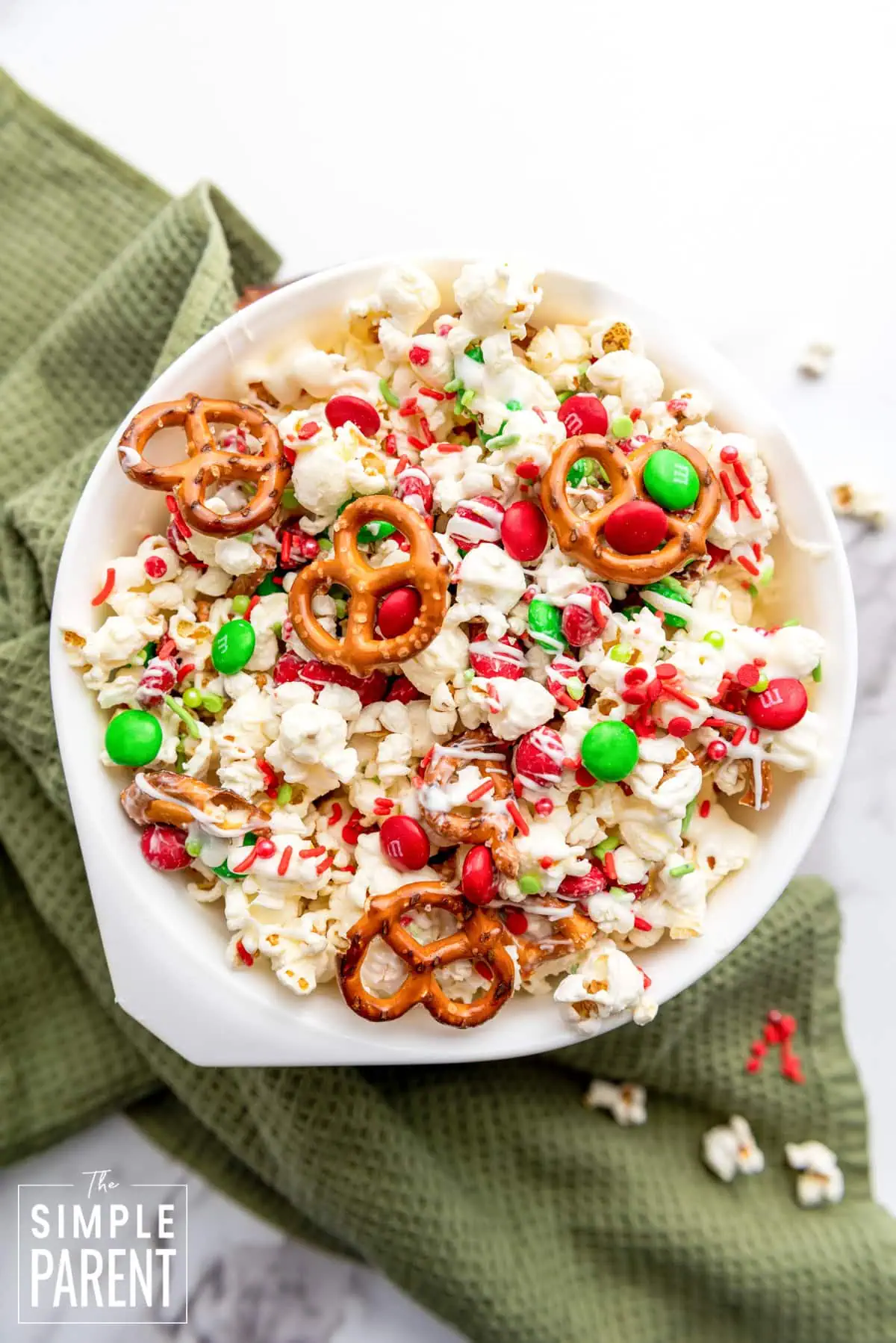 Christmas popcorn mix in a white bowl