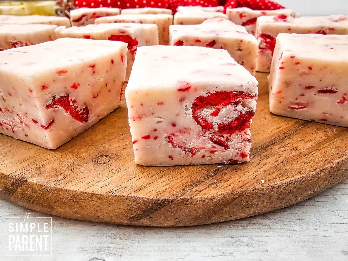 Pieces of strawberry fudge on wooden cutting board