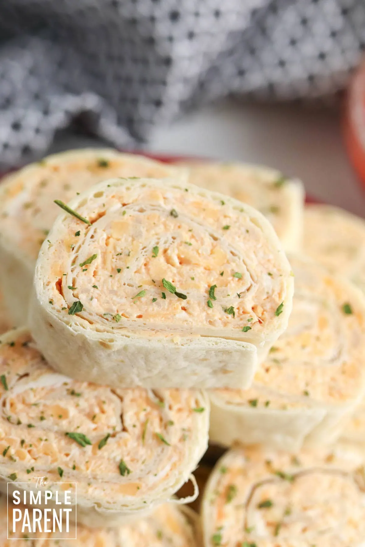 Spicy Buffalo Chicken Tortilla Pinwheels stacked on plate
