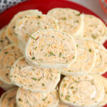 Buffalo Chicken Pinwheels stacked on red plate