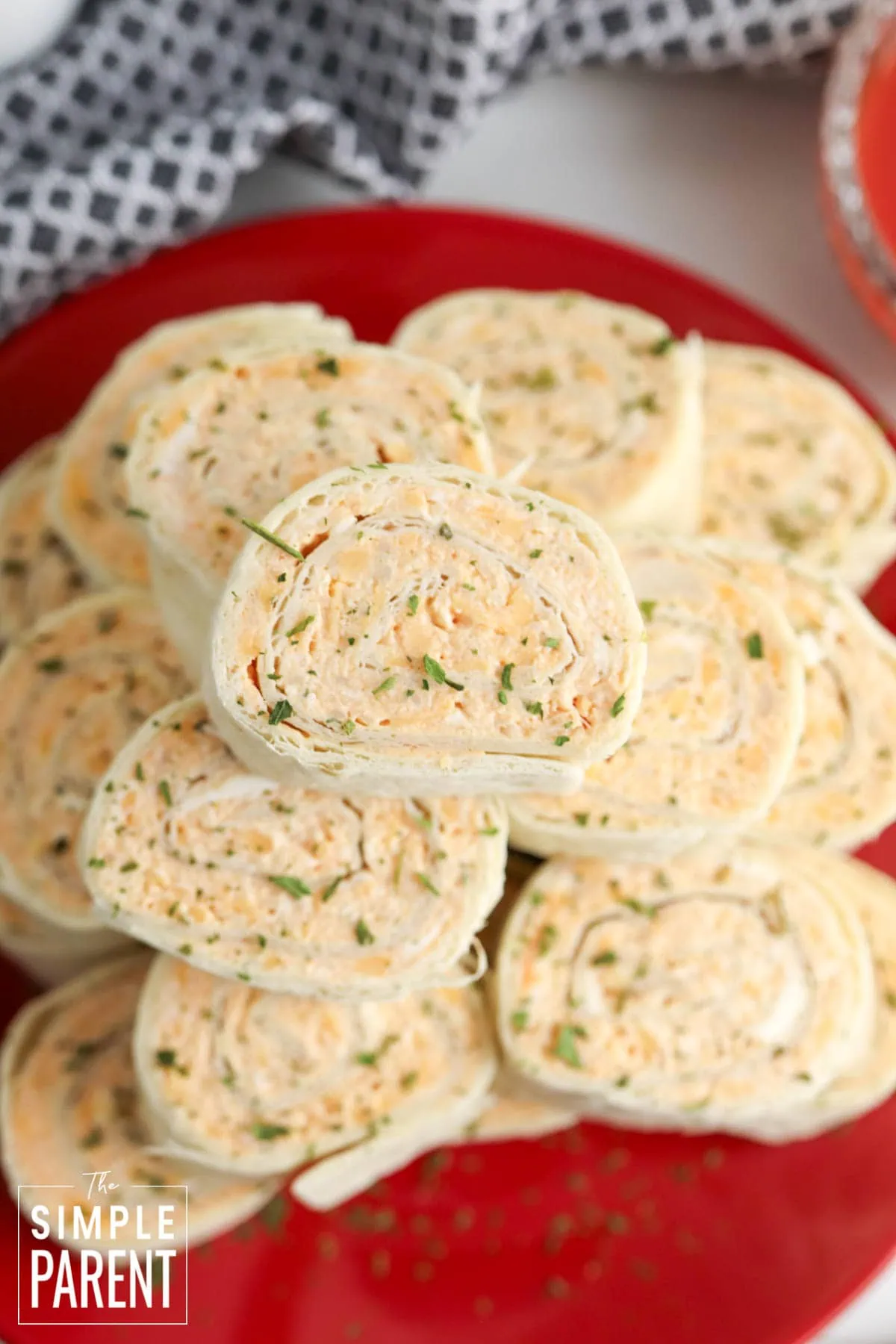 Buffalo Chicken Pinwheels stacked on red plate