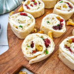 Chicken Cranberry Pinwheels on wooden serving board