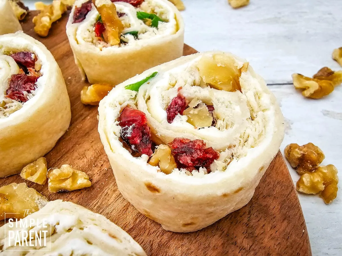 Chicken Pinwheels with Cranberries on wood plate