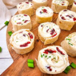 Cranberry feta pinwheels on wood serving board