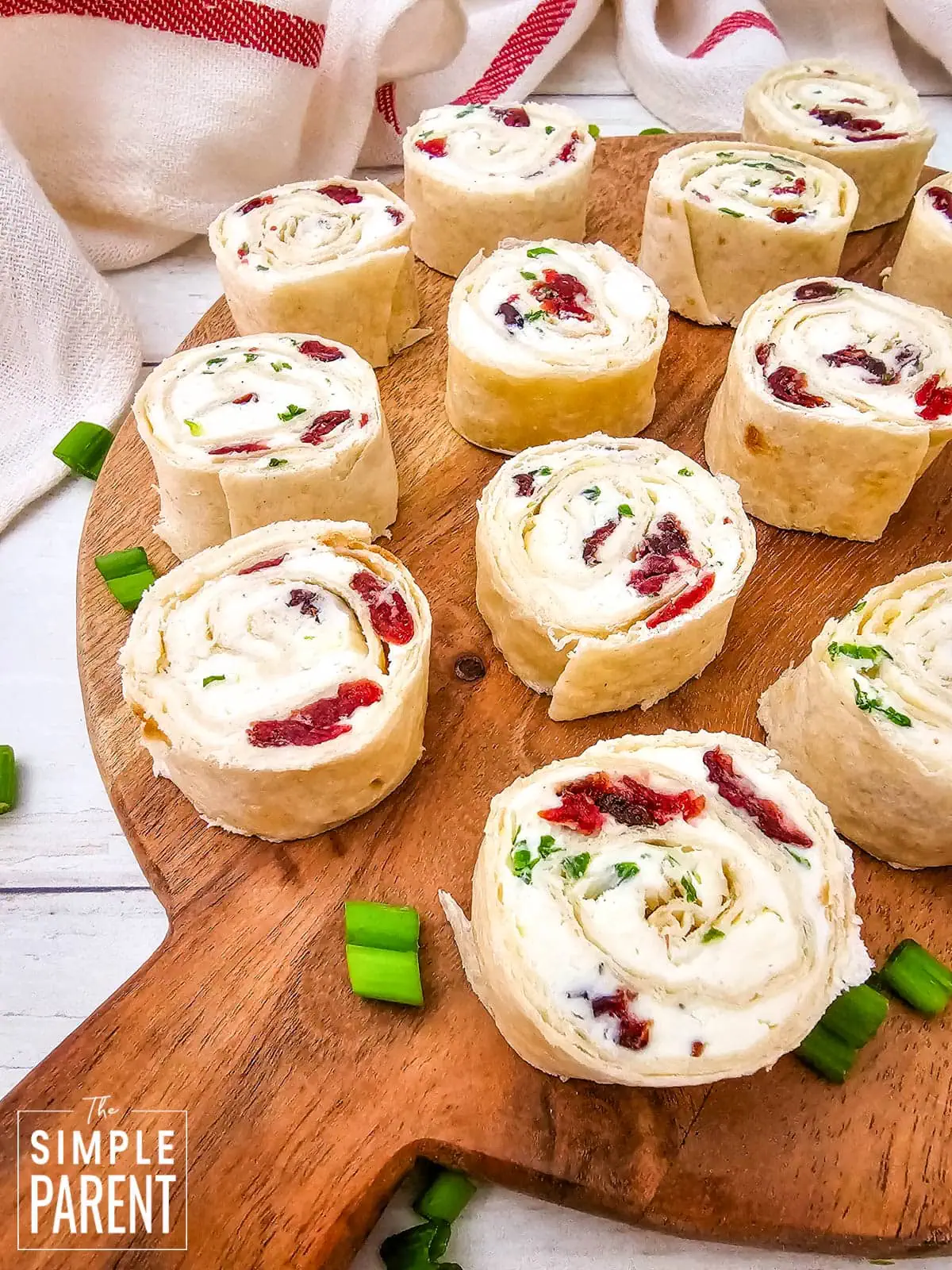 Cranberry feta pinwheels on wood serving board