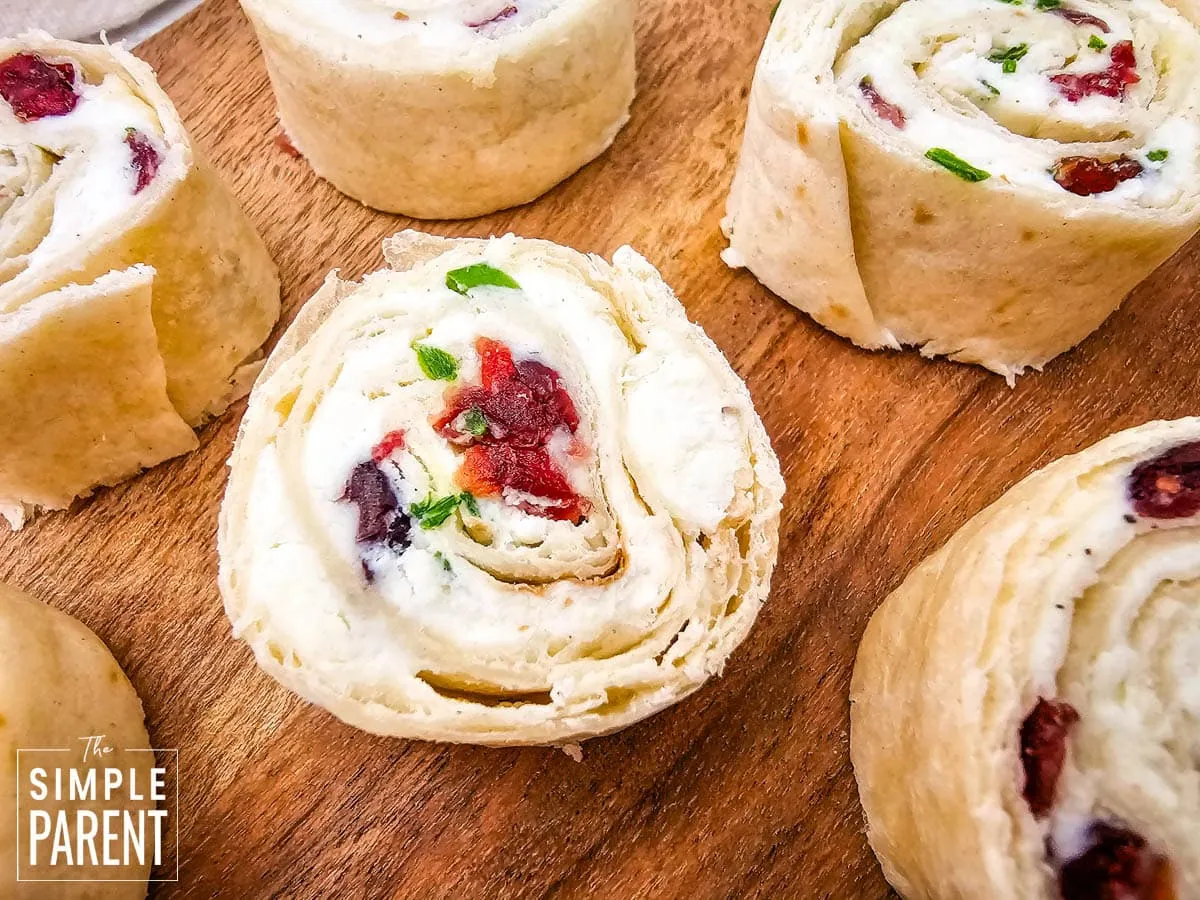 Feta cranberry pinwheels on wood plate