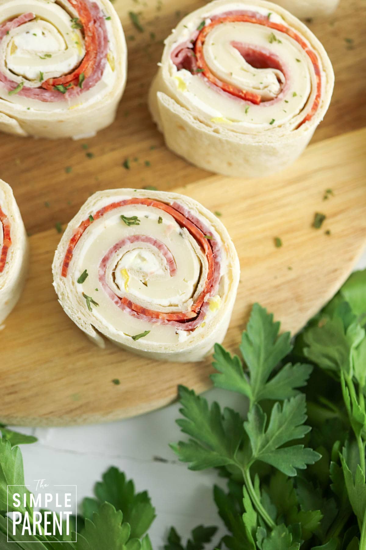 Italian pinwheel appetizers on wooden cutting board
