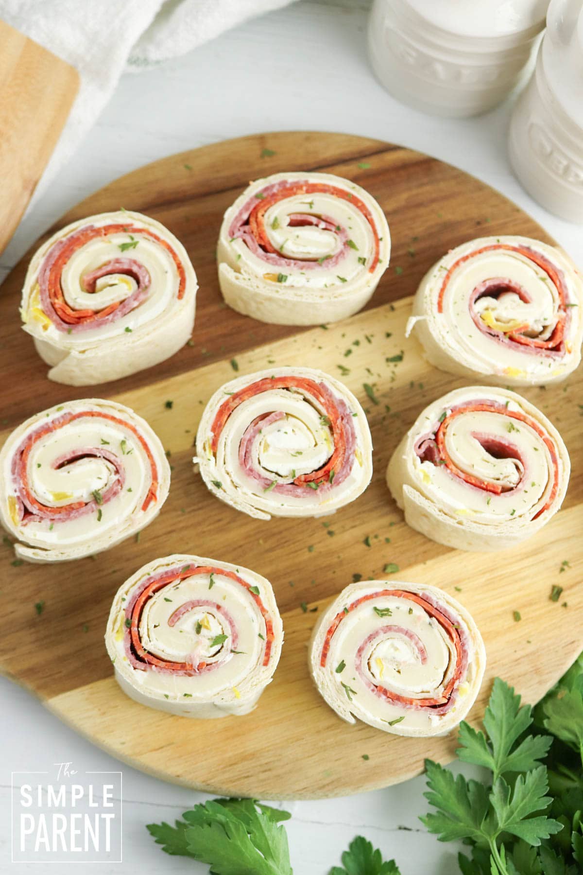 Italian pinwheel sandwiches on wooden cutting board