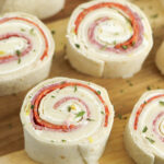 Italian Pinwheels on wooden serving plate