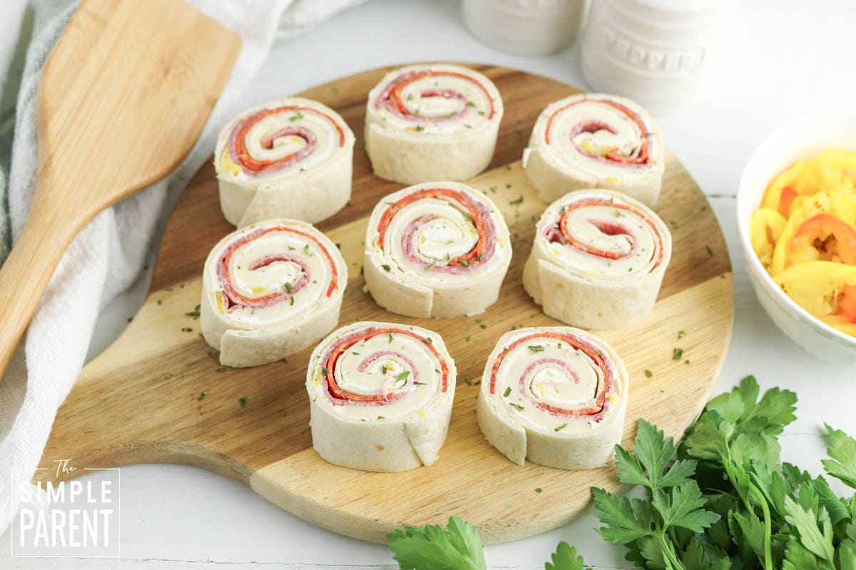 Italian Roll Ups on wooden serving board