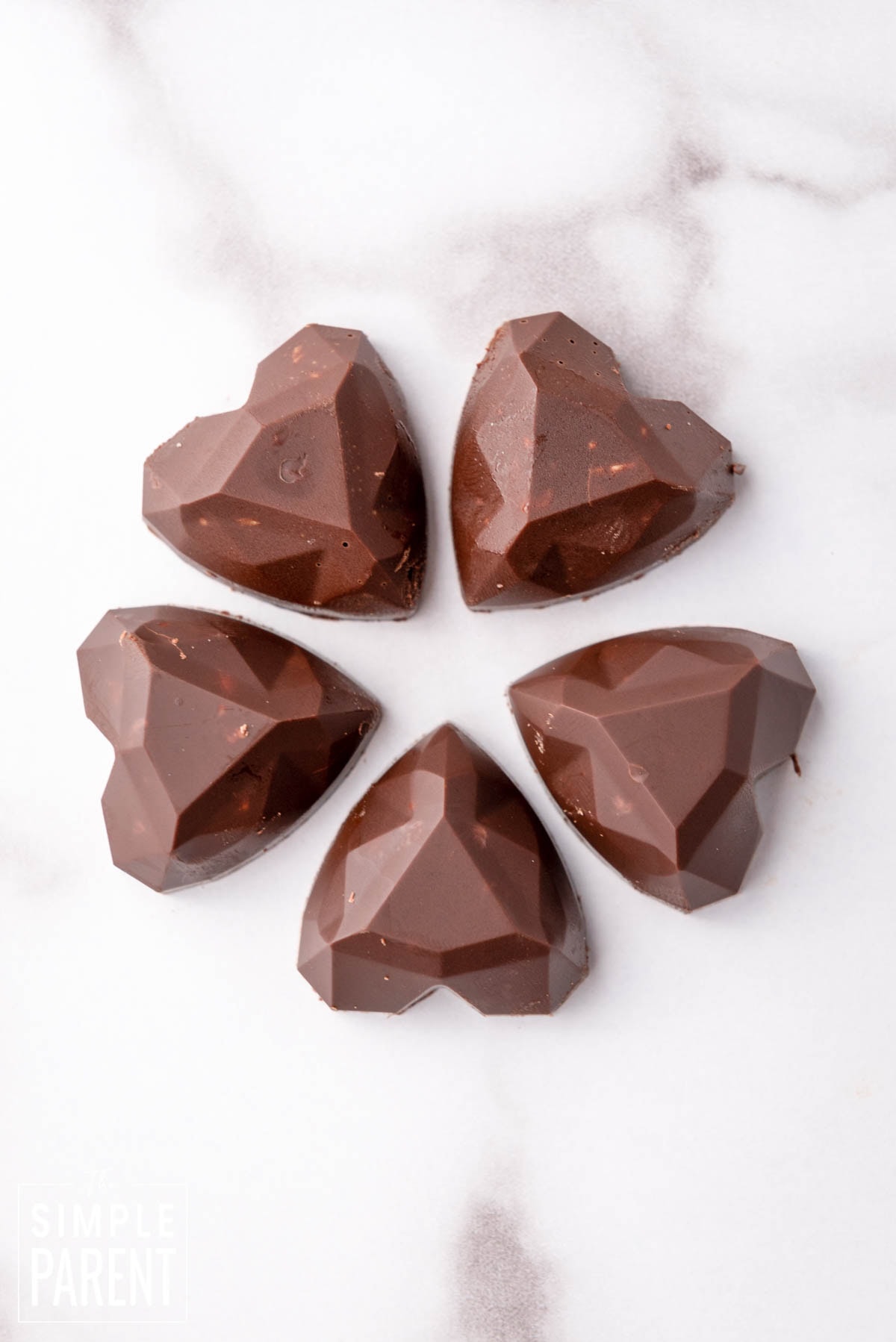 Heart shaped Nutella fudge bites on white counter