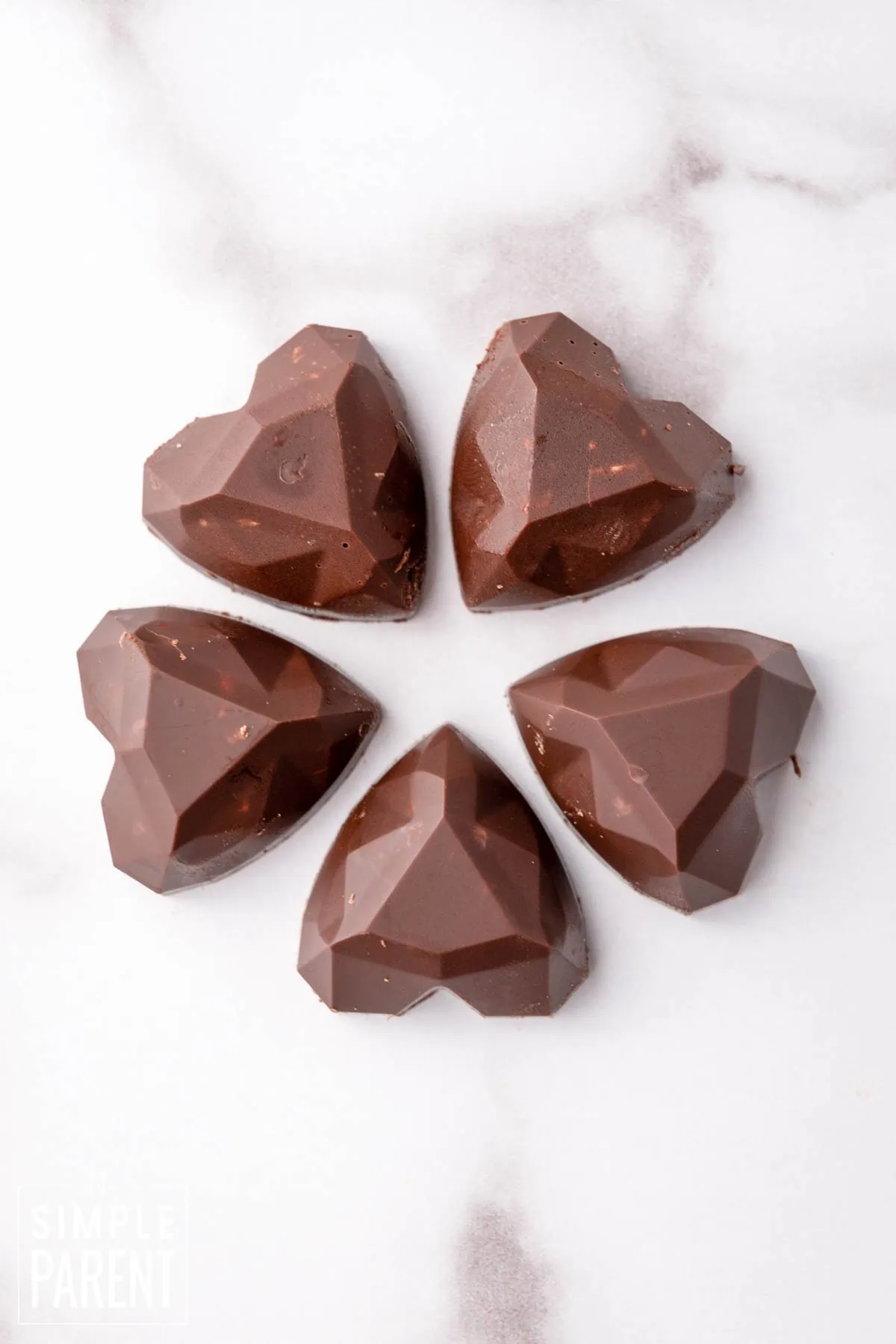 Heart shaped Nutella fudge bites on white counter