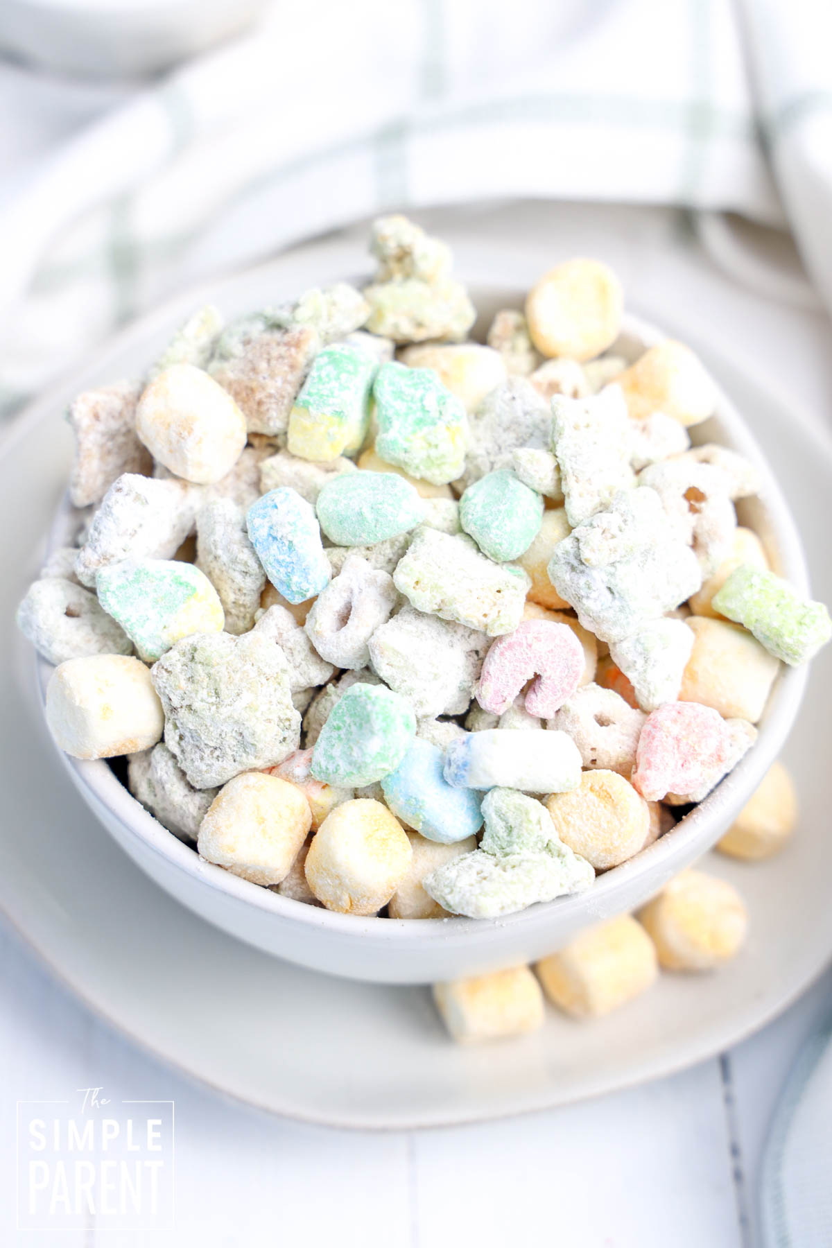 Holiday Puppy Chow for St. Patrick's Day made with Lucky Charms in a white bowl