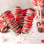 Valentine Marshmallow pops cover in chocolate with red sprinkles in a glass jar