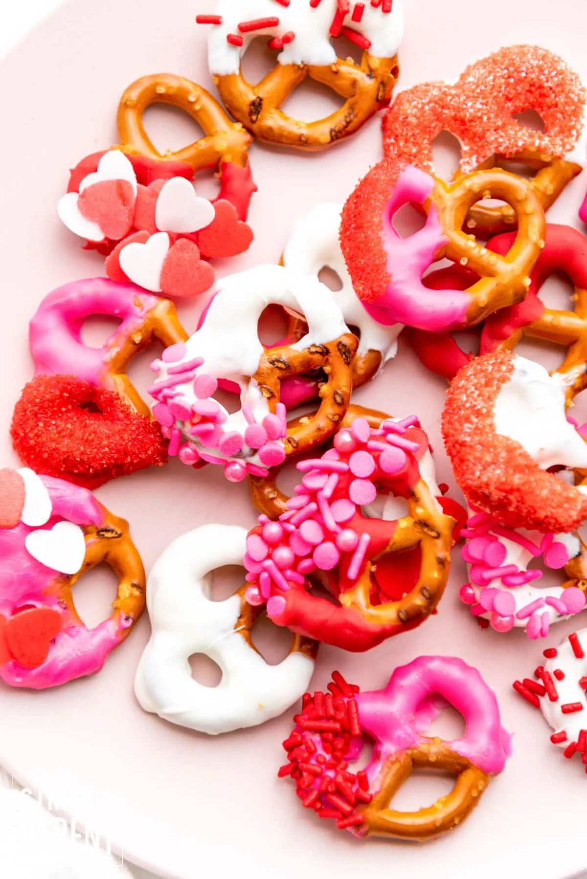 Valentine Pretzels dipped in red, white and pink cholcate on white counter