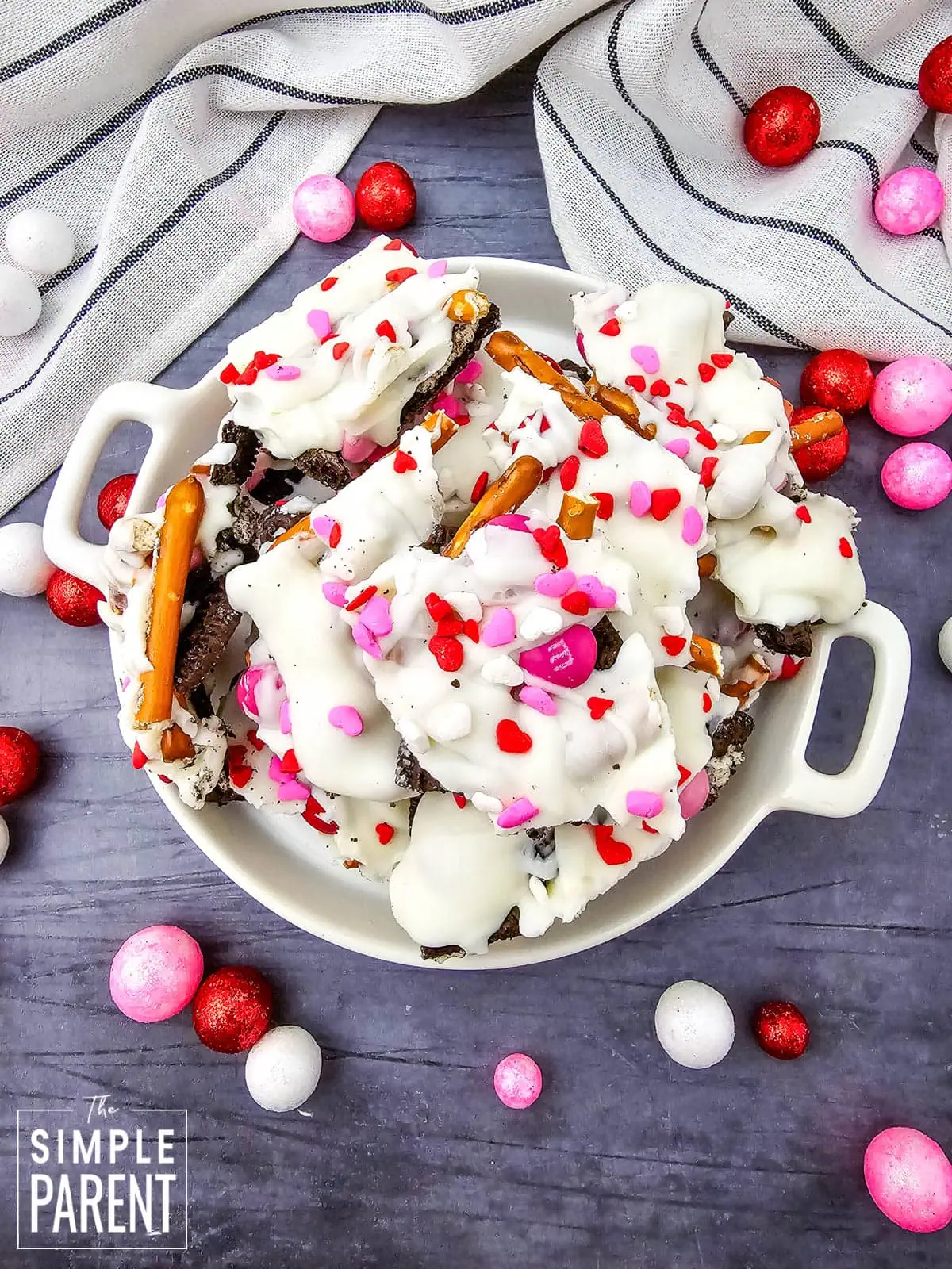 Pieces of Valentine's Day Bark in white bowl on dark gray counter