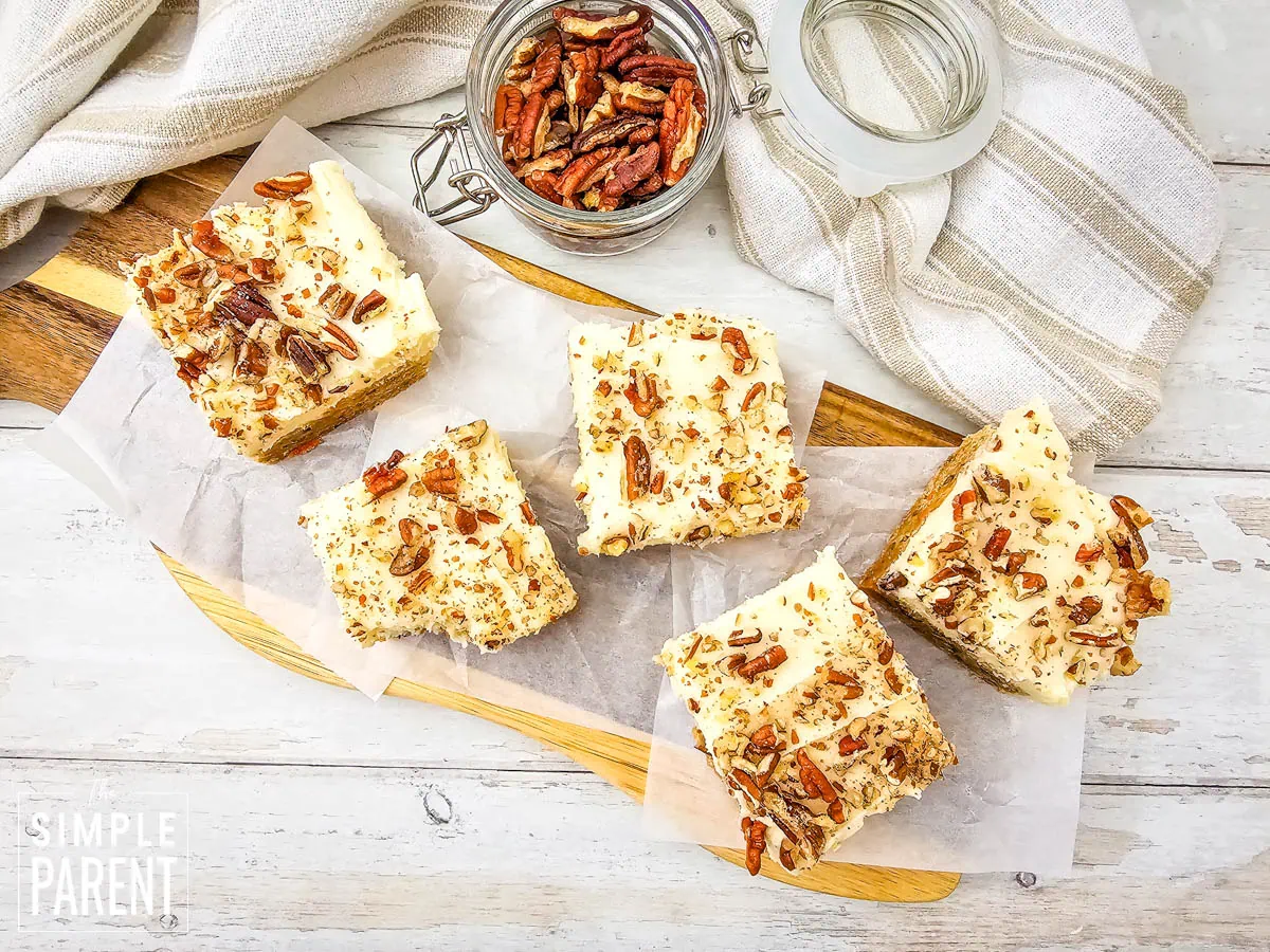 Carrot Cake Bars on parchment paper with nuts