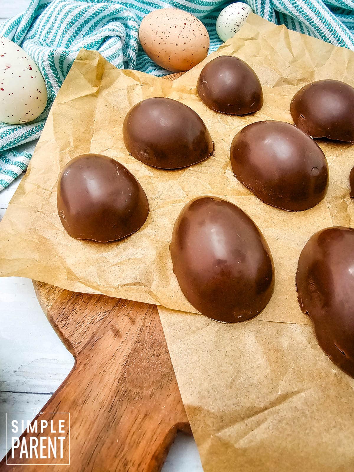 chocolate peanut butter eggs on parchment paper on wooden board