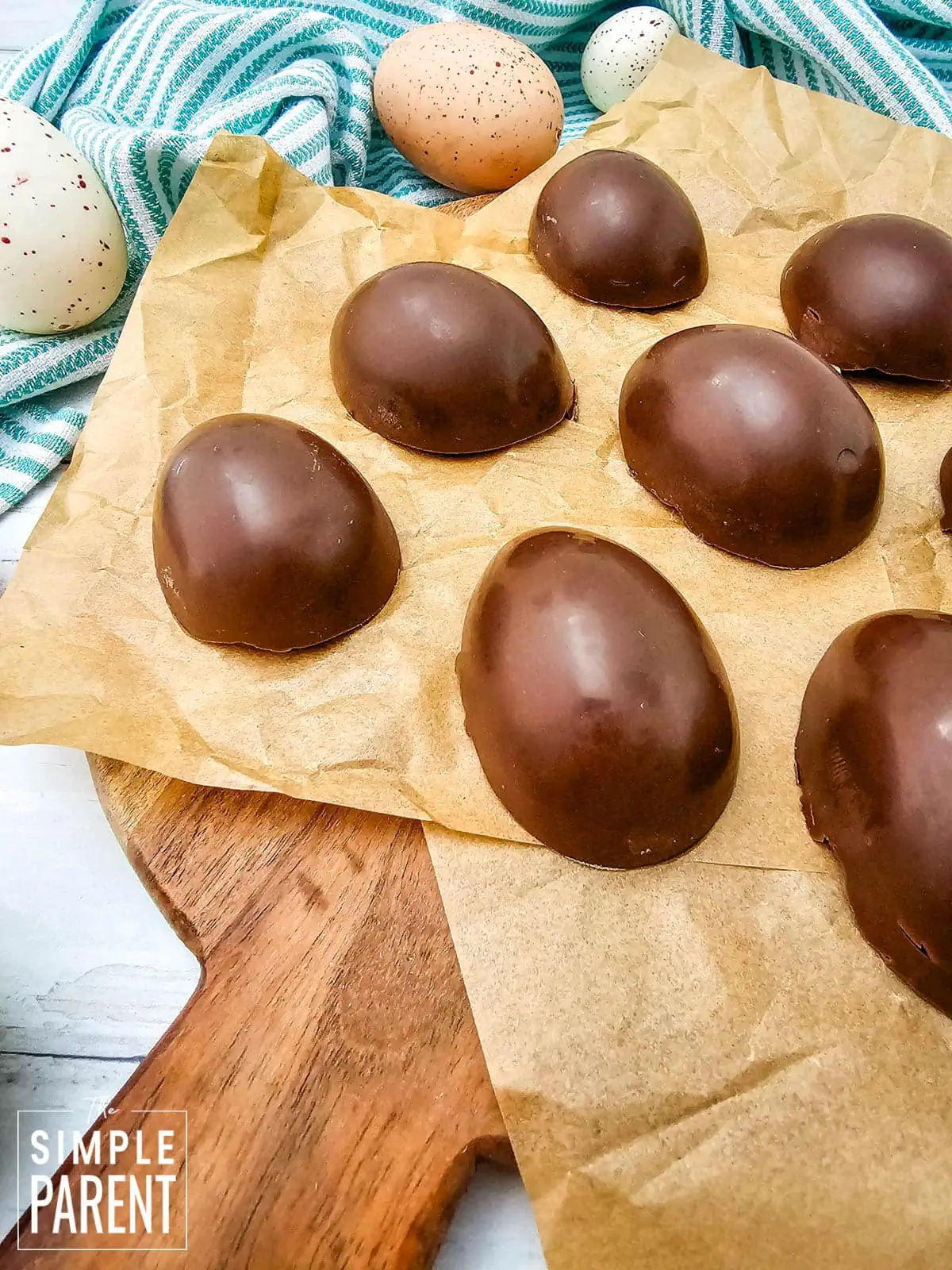 chocolate peanut butter eggs on parchment paper on wooden board