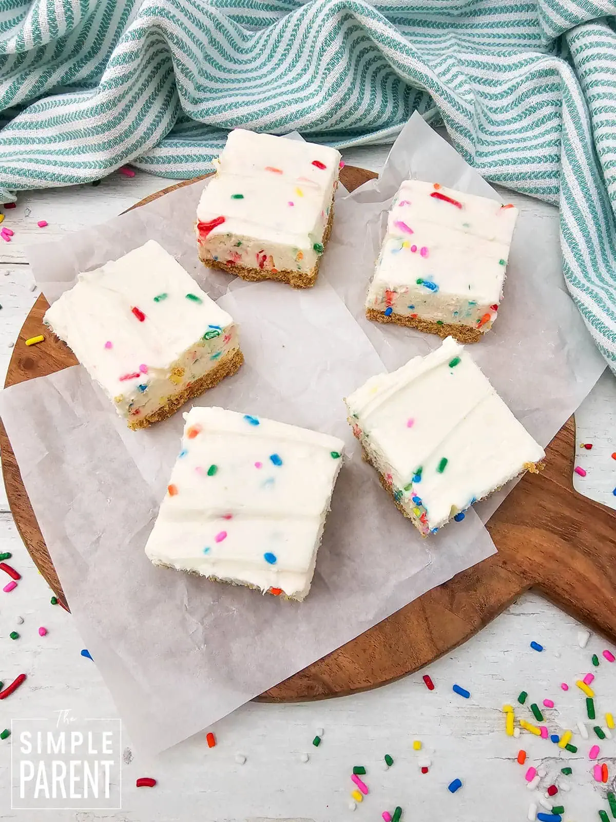Funfetti Cheesecake Bars on wooden serving board