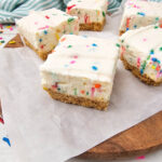 No Bake Funfetti Cheesecake Bars on parchment paper
