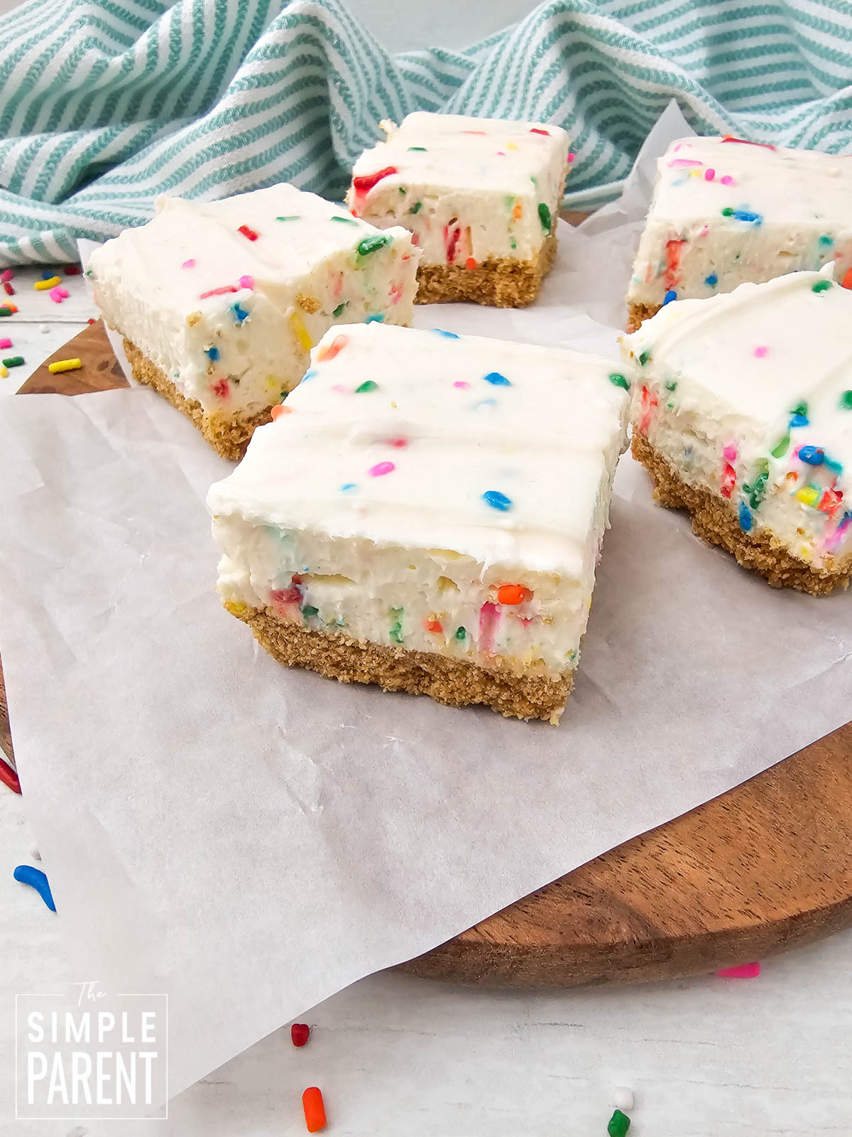 No Bake Funfetti Cheesecake Bars on parchment paper