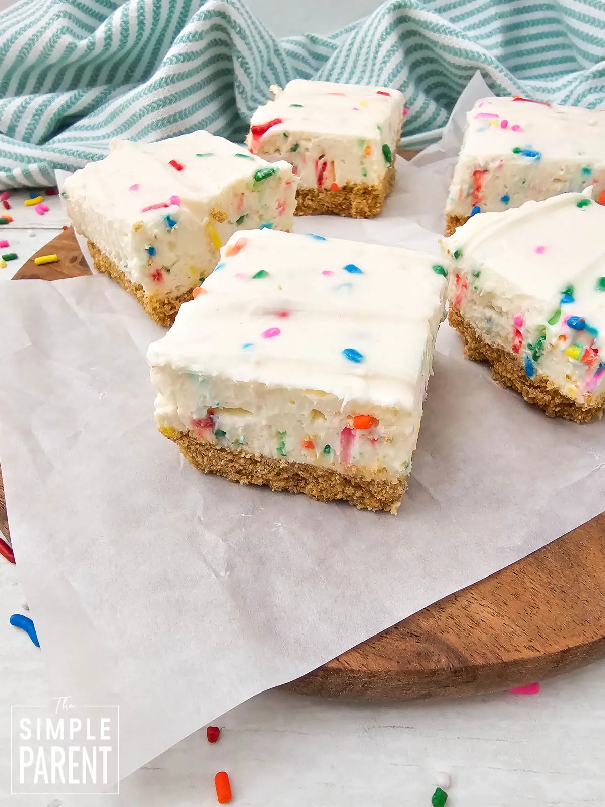 No Bake Funfetti Cheesecake Bars on parchment paper