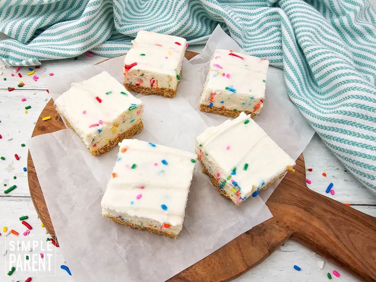 No Bake Funfetti Cheesecake Squares on wooden serving board