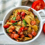 Bruschetta pasta salad in white bowl