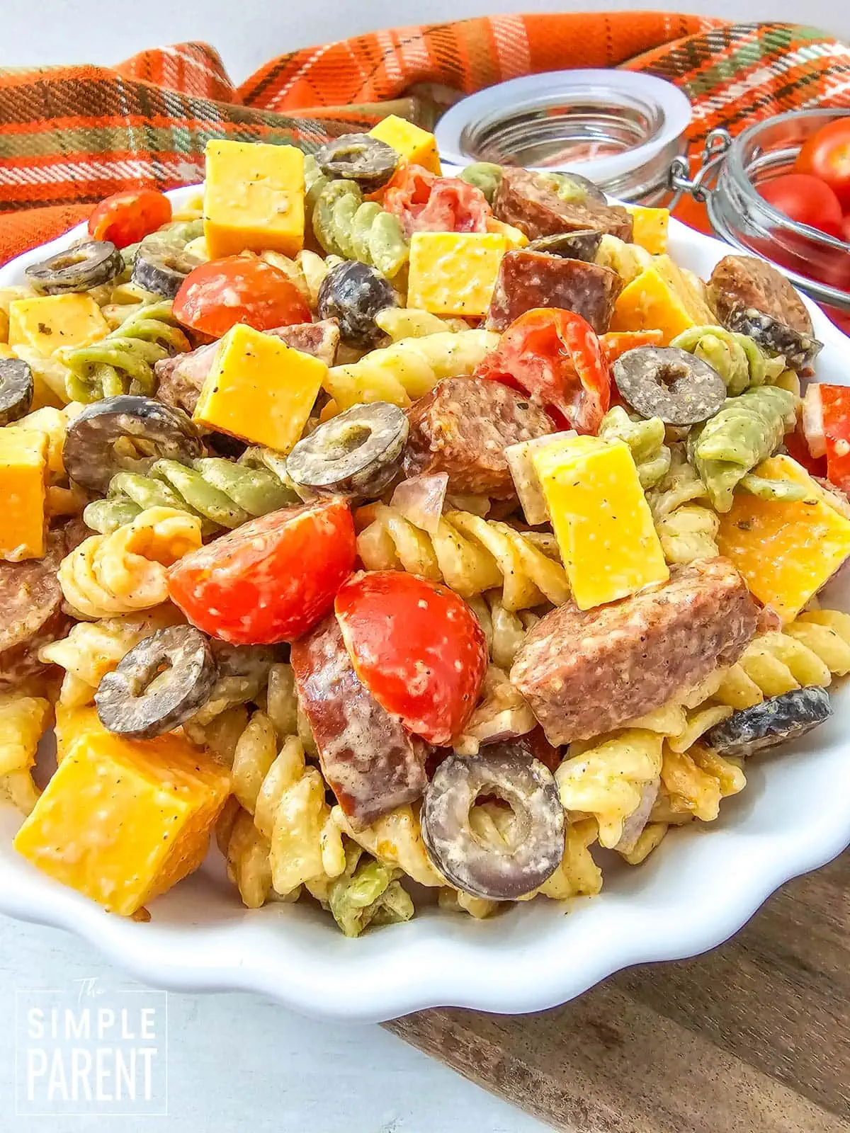 pasta salad with sausage in white serving bowl