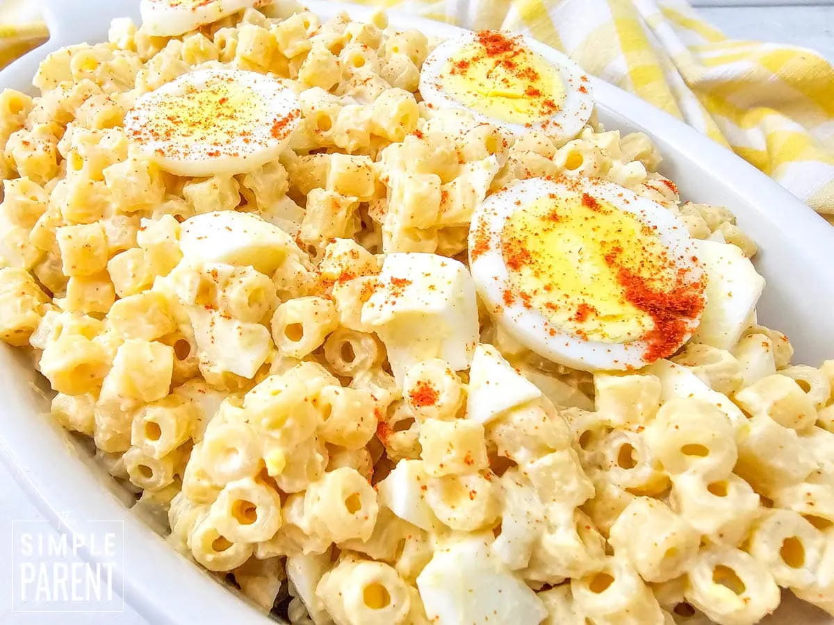 Creamy Deviled Egg Macaroni Salad in white serving dish
