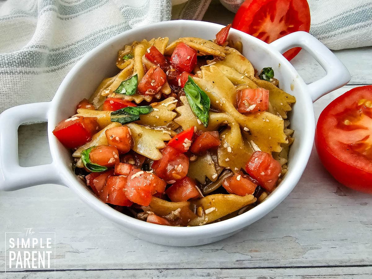 Cherry tomato bruschetta pasta salad in white serving bowl