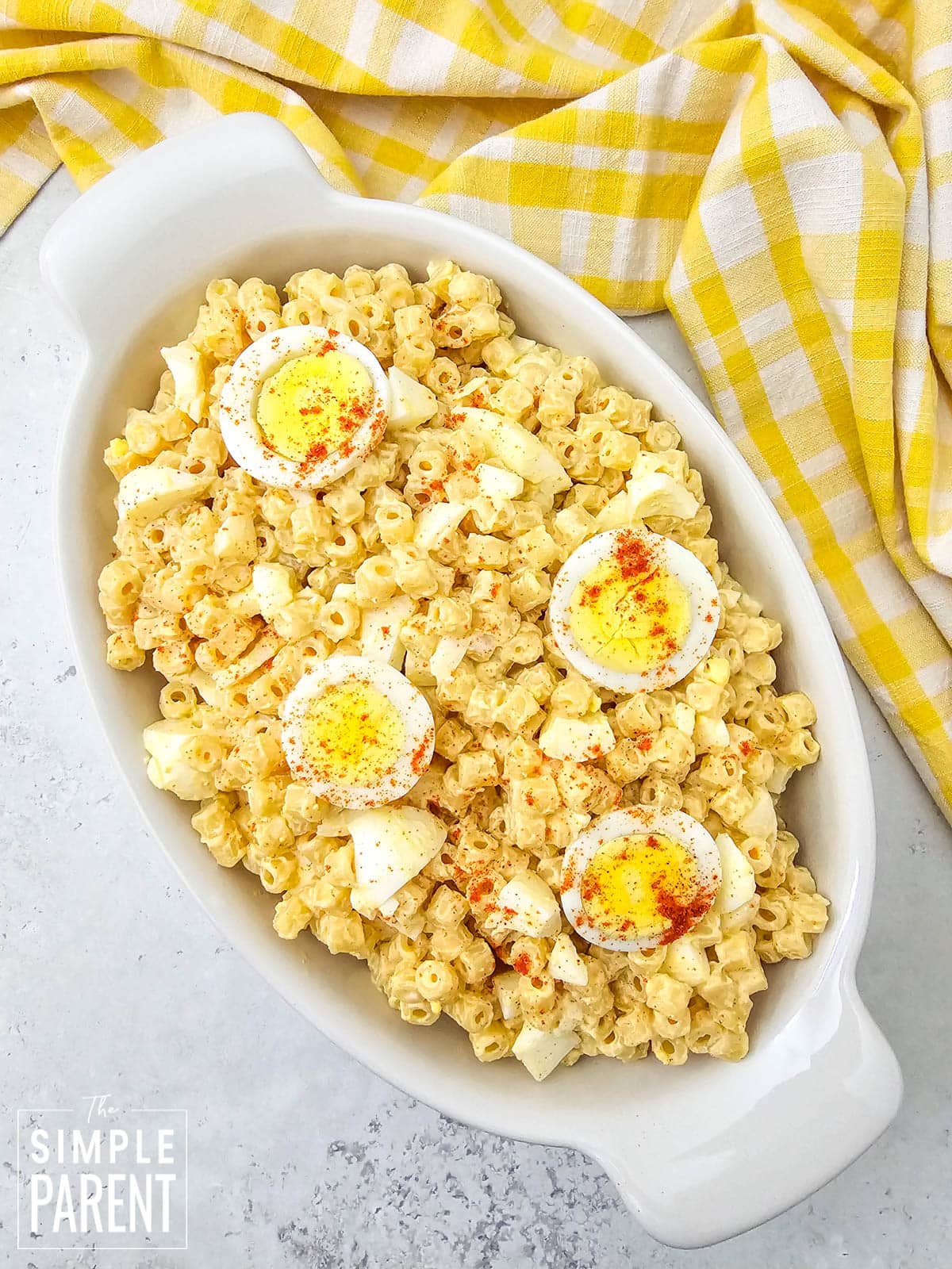 Macaroni Salad With Egg in white serving dish