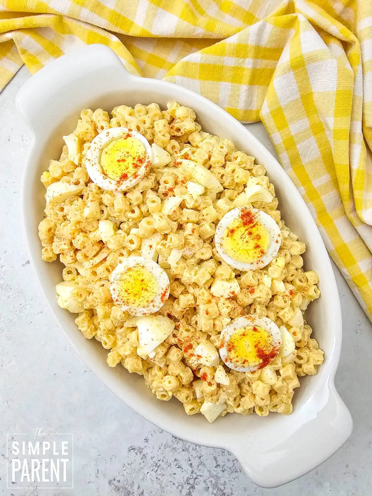 Macaroni Salad With Egg in white serving dish