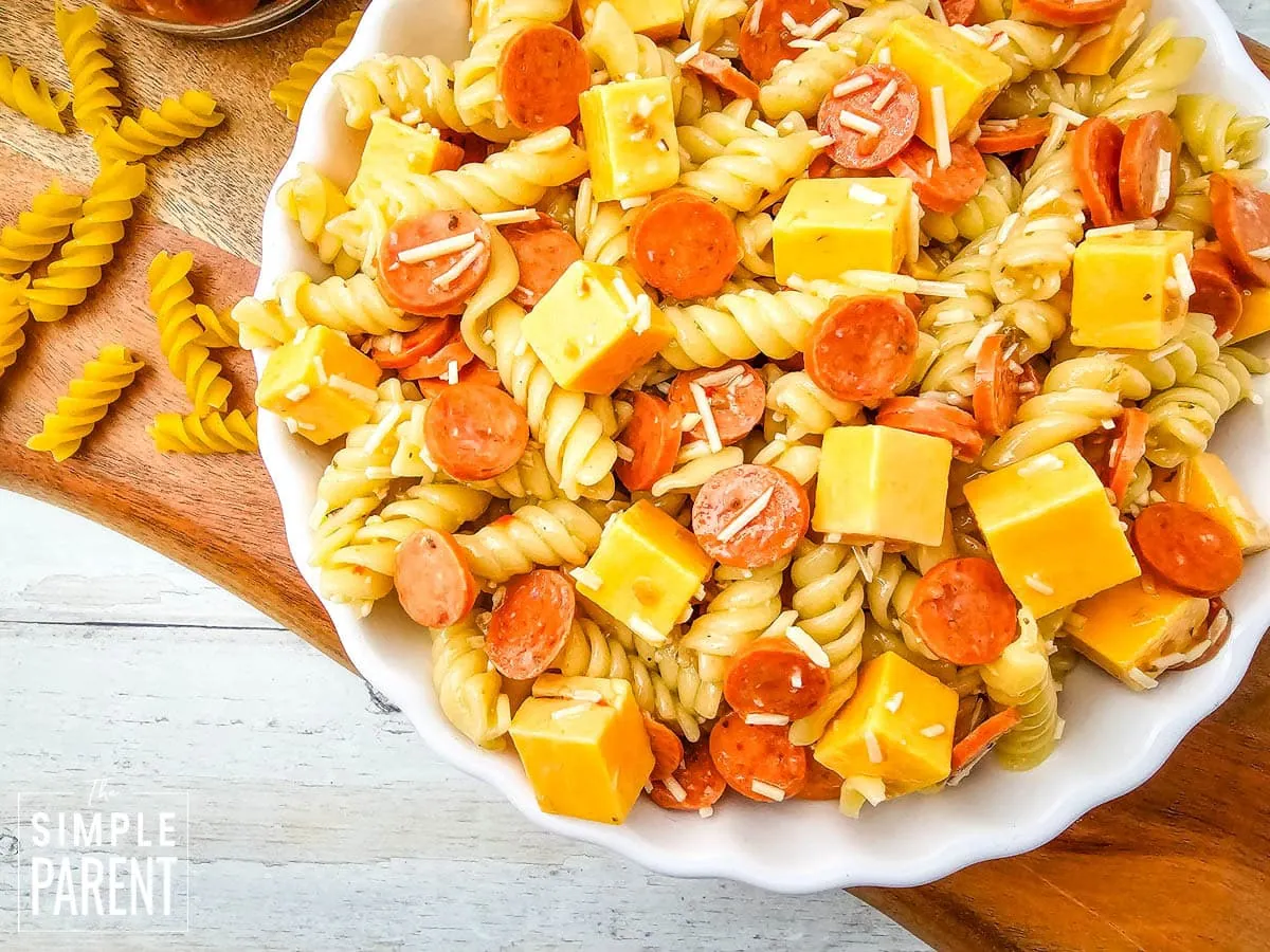 pasta salad with pepperoni and cheese in white bowl
