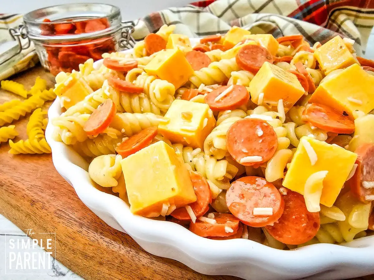 Pasta salad with pepperoni in white bowl
