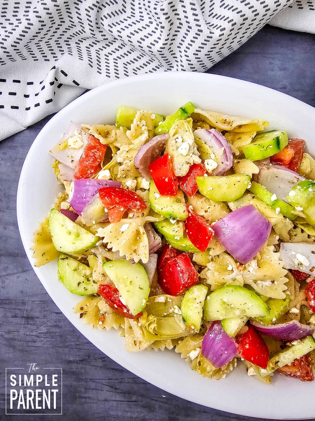 Greek pasta salad with feta in white serving dish