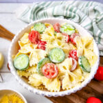 Cold Bowtie pasta salad for parties and potlucks in white serving bowl