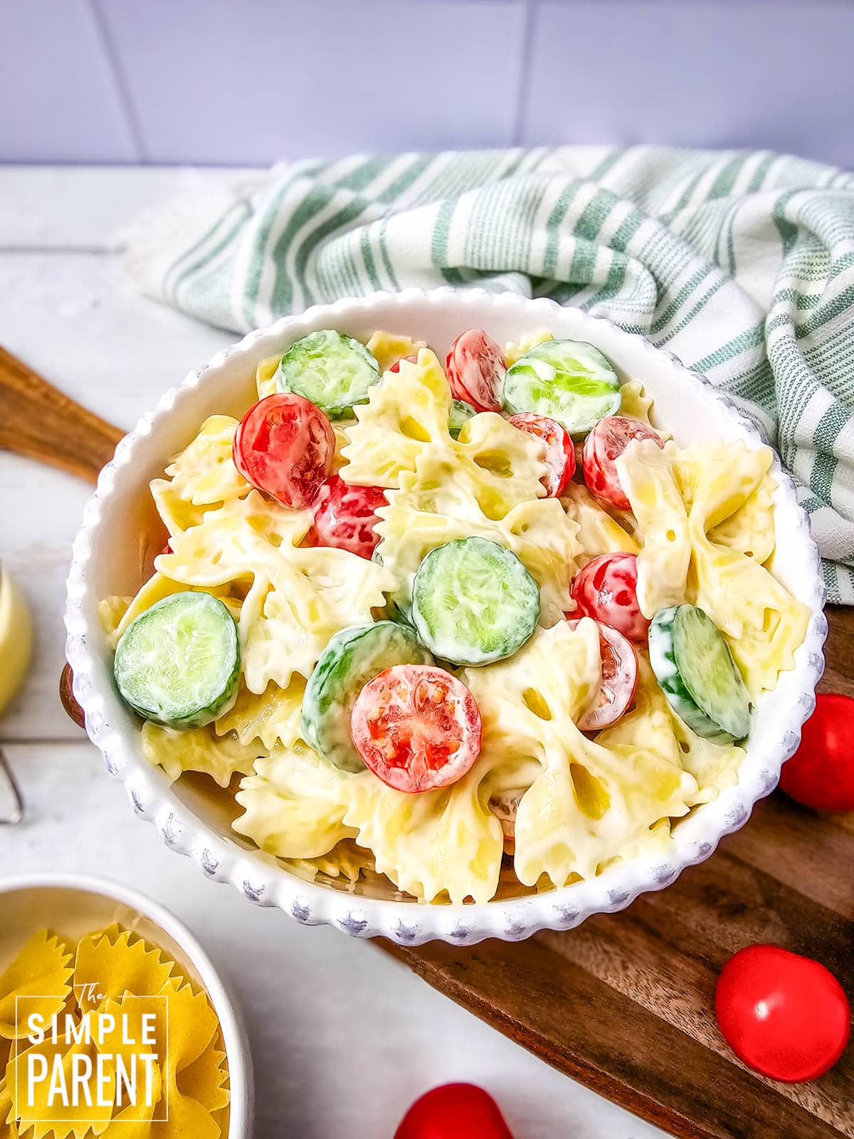 Cold Bowtie pasta salad for parties and potlucks in white serving bowl