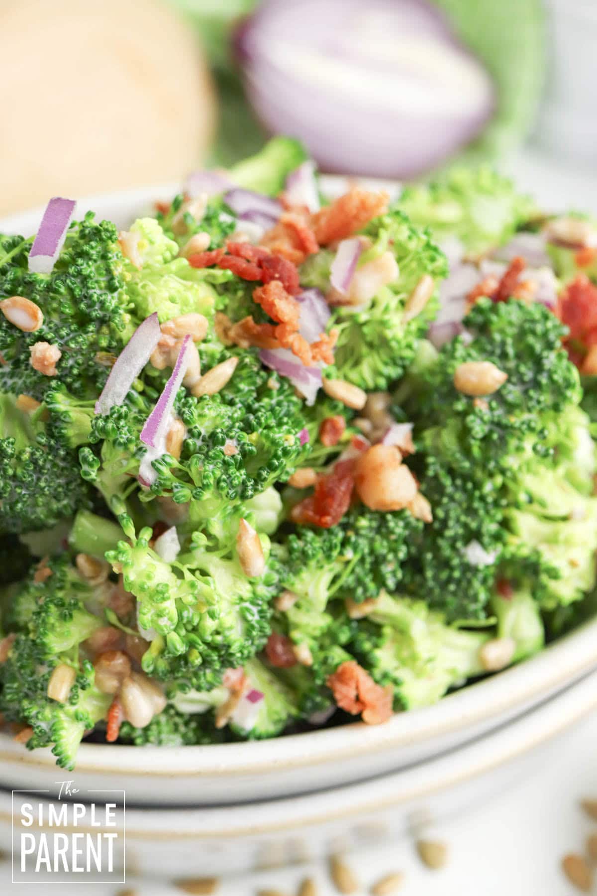 Easy Old Fashioned Broccoli Salad for Thanksgiving and Potlucks in white serving bowl
