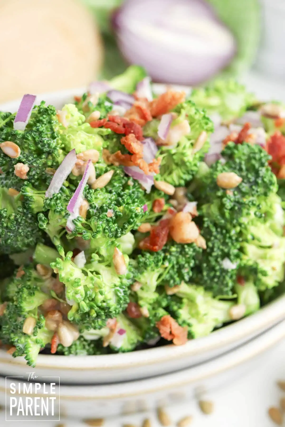 Easy Old Fashioned Broccoli Salad for Thanksgiving and Potlucks in white serving bowl