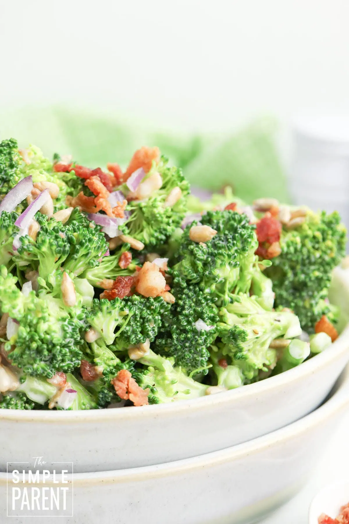 broccoli slaw salad in white serving bowl