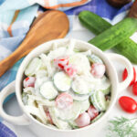Easy Creamy Cucumber Salad with Tomatoes in white serving bowl