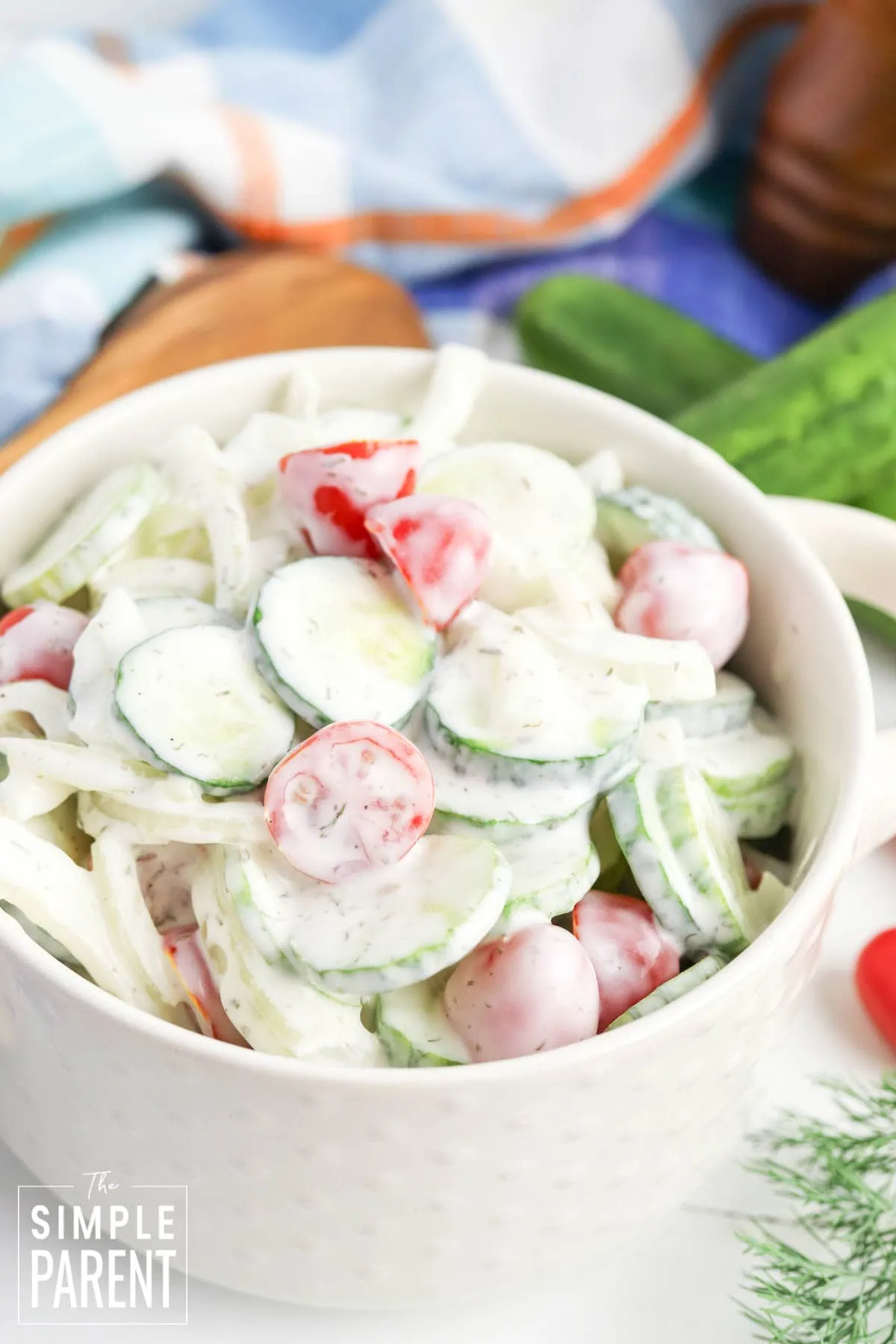 creamy cucumber salad with mayonnaise in white serving bowl