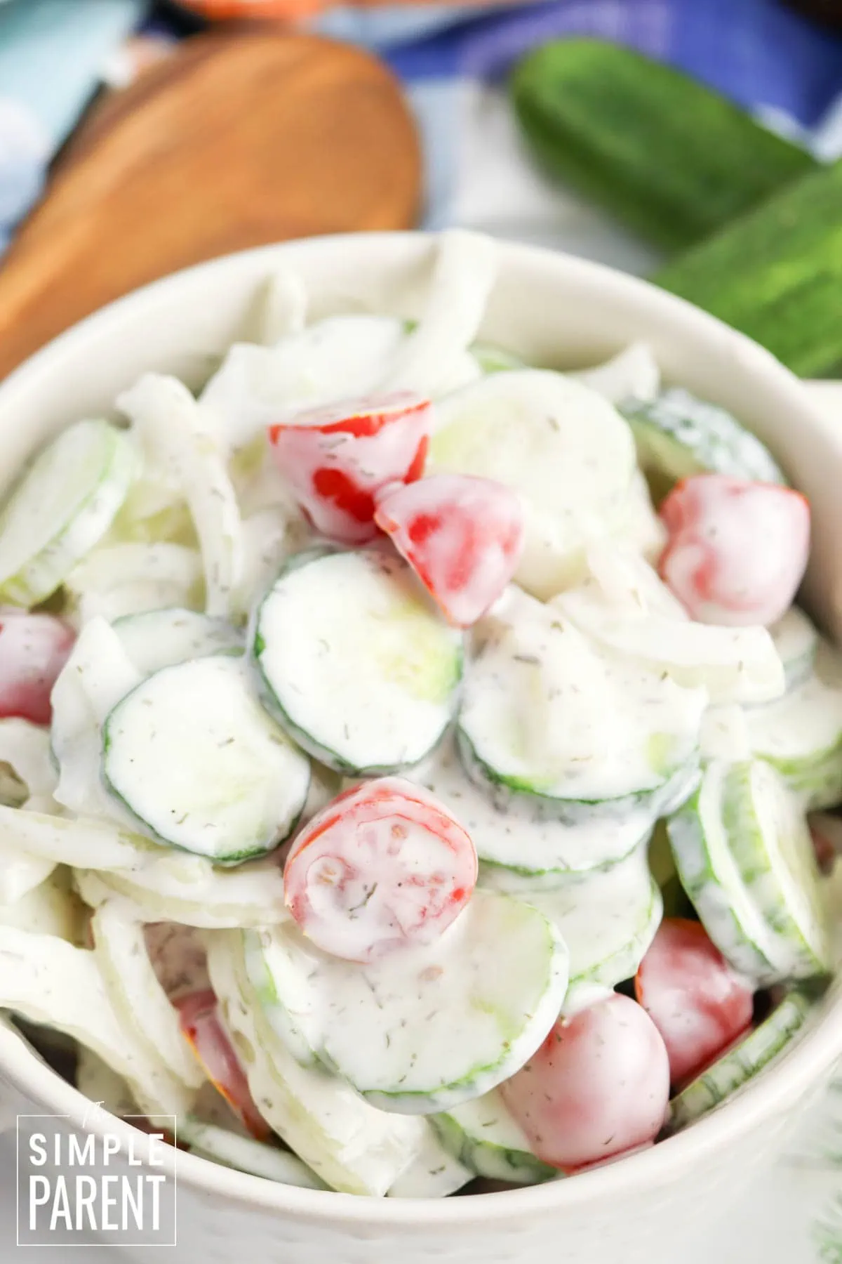 cucumber dill salad in white serving bowl